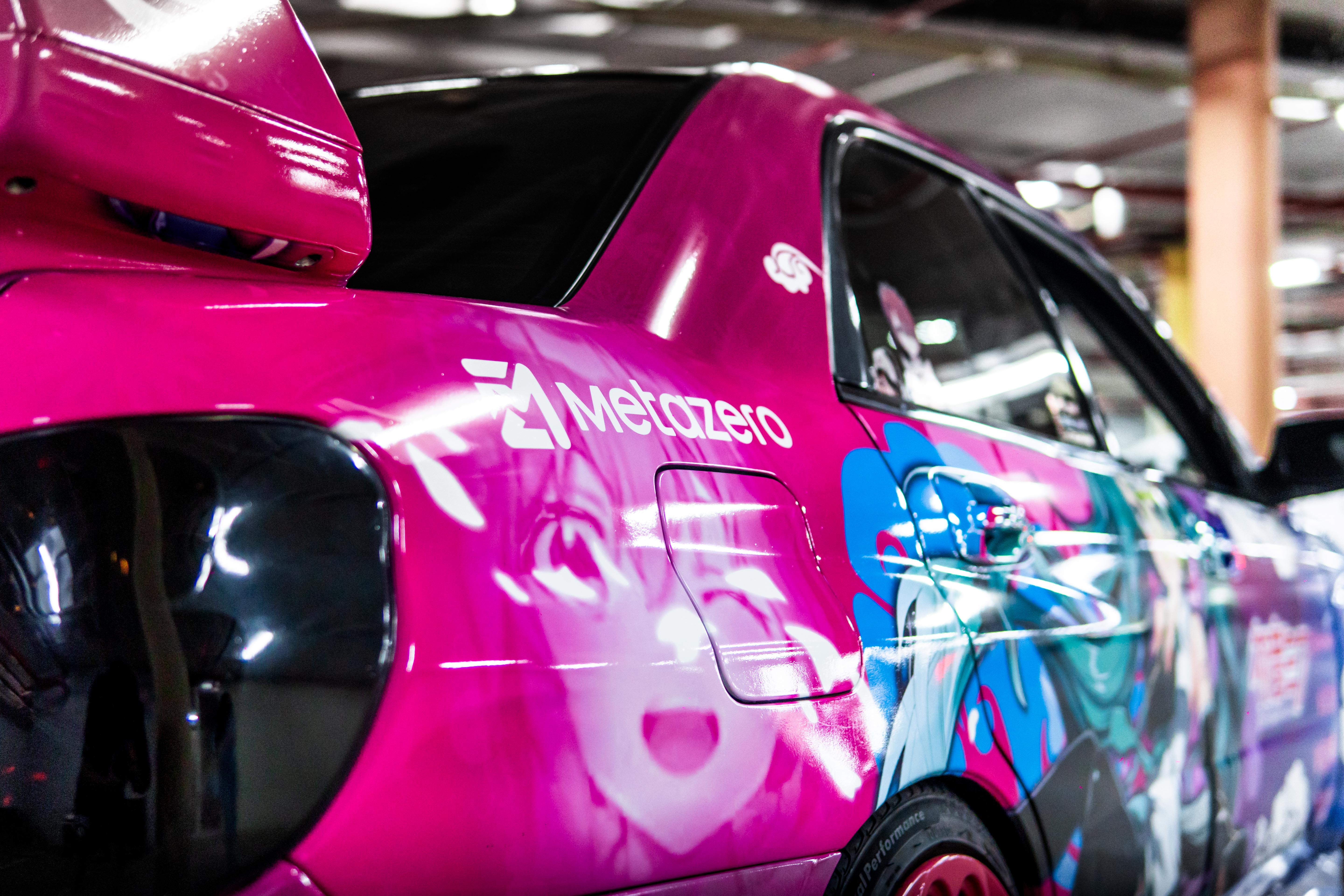 Pink car with Metazero branding in a garage setting