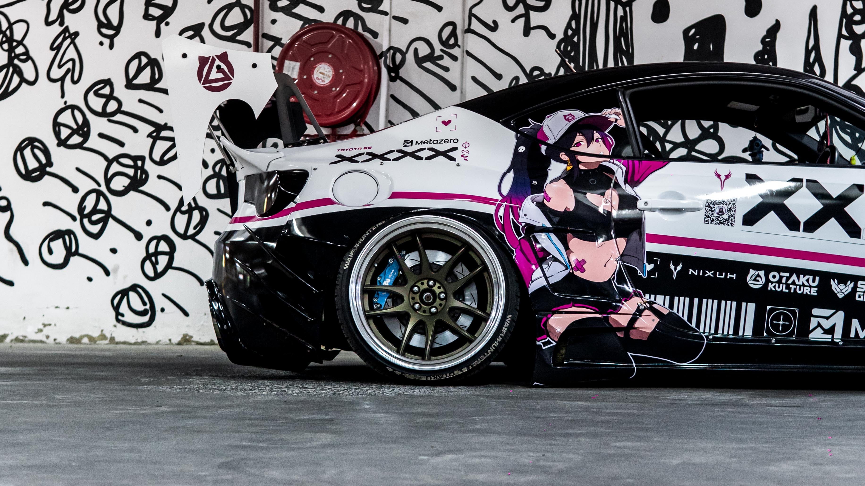 Toyota 86 Car with 'printstream' branding parked in a garage with a graffiti-covered wall.